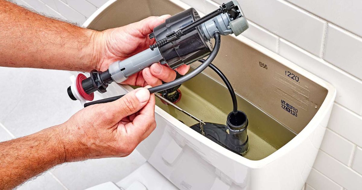 Inside a toilet tank showing the flapper and fill valve